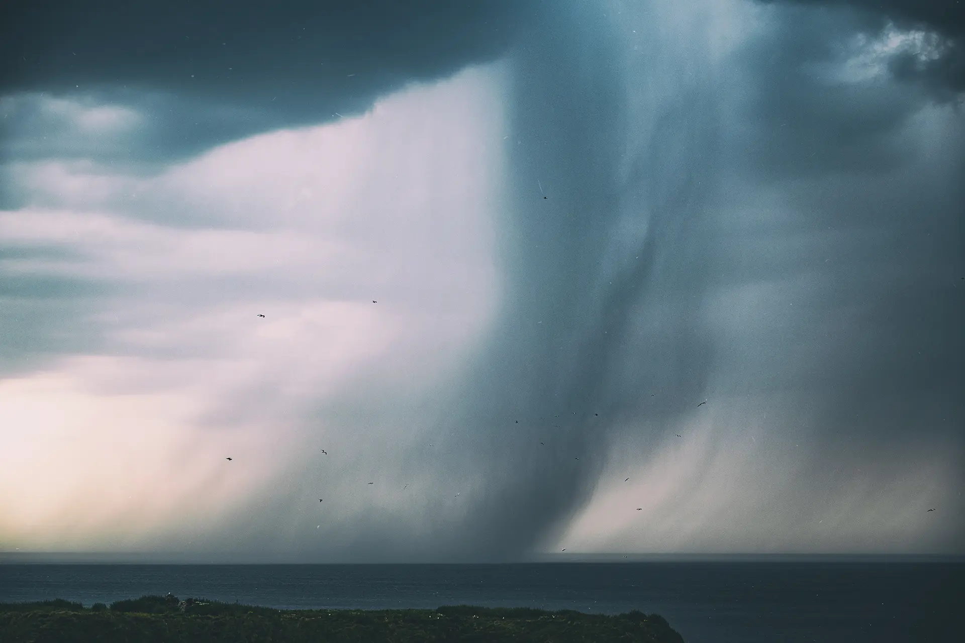 Stormy sky and rain over ocean